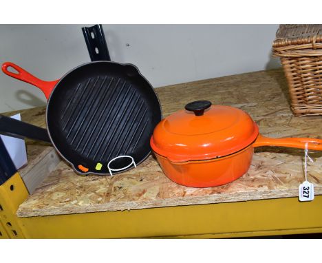 A SET OF LE CREUSET VOLCANIC ORANGE CAST IRON OVEN WARE, comprising a classic 23cm  lidded saucepan/casserole dish with handl