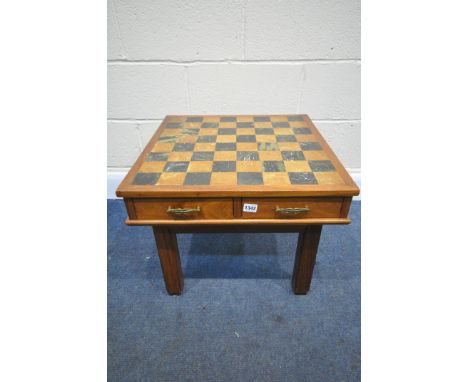 A HARDWOOD GAMES TABLE, with a chess board playing surface, and two drawers enclosing an African chess set that's baize lined