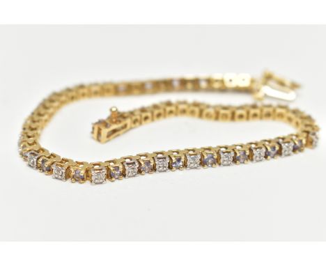 A YELLOW METAL AND GEMSET BRACELET, a yellow metal line bracelet set with thirty round brilliant cut diamonds in an illusion 