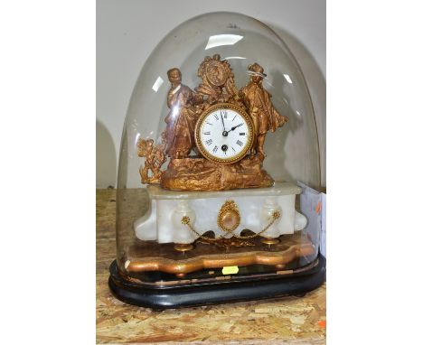 A GILT FRENCH ROCOCO STYLE MANTLE CLOCK, on an ebonized stand with a large glass dome, the figural gilt clock is supported by