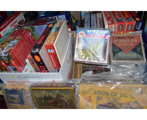 FOUR BOXES OF JIGSAW PUZZLES, approximately thirty five puzzles including six vintage puzzles, eight modern puzzles still sea