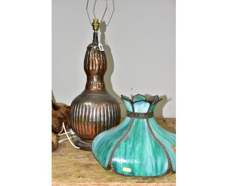 A TIFFANY STYLE TABLE LAMP, with a green and white opaque leaded glass shade, an Asian style distressed coppered metal bulbou