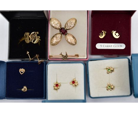 A SELECTION OF YELLOW METAL EARRINGS AND TWO BROOCHES, to include a pair of openwork yellow metal elephant stud earrings, pos