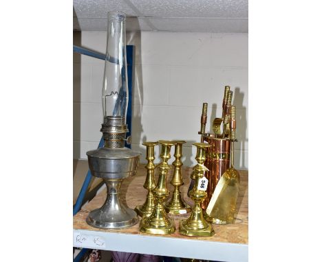 A GROUP OF METALWARES, comprising a Super Aladdin oil lamp (chimney cracked), two pairs of brass candlesticks heights 24.5cm 