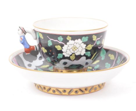 Herend - A vintage 20th century Herend Macao pattern demitasse and saucer. The cup and saucer having polychrome floral decora