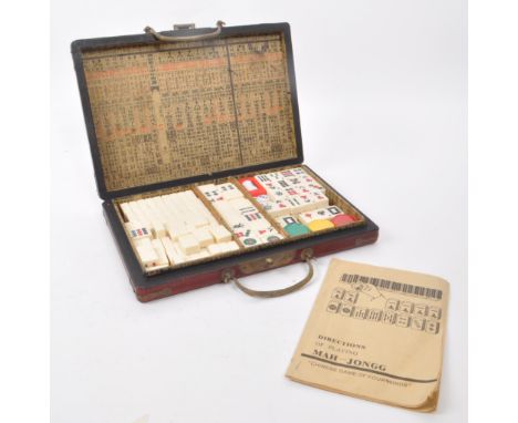 A vintage mahjong game set with decorative case, 1960s-1980s approximate origin. Contains plastic tiles, counters, instructio