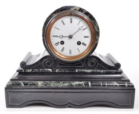 A Victorian 19th century black slate and green marble mantel clock with key. Having an 8 day movement, with white enamelled f