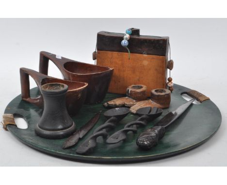 Collection of African Tribal carved wooden pieces, comprising of: two kuksa style cups, two knives, two foot shaped candle st