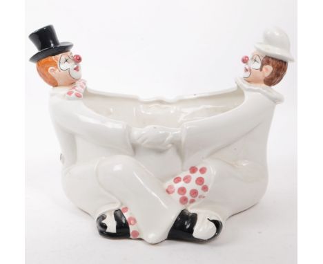 A mid 20th century Italian ceramic clown plant pot, featuring a pair of clown figures in the shape of the pot, with hand pain