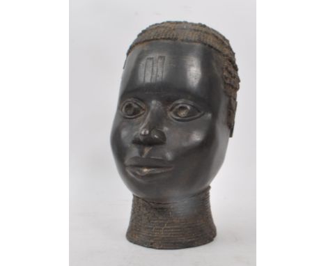 A vintage early 20th century bronze metal African tribal bust, of a woman. Hollow to the inside of the sculpture and a hole t