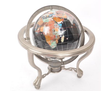 A vintage 20th century gemstone inlaid desktop globe. The globe of black ground featuring precious stone inlaid countries. He