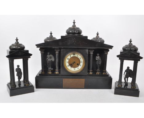 An antique 1910 French slate mantel clock garniture, in three pieces. The slate clock features an enamel chapter ring with Ar