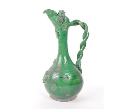 A 19th century Turkish Ottoman canakkale pottery ewer, with a green glaze. Featuring a braided handle. ceramic and painted fl