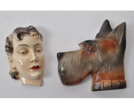 Two early 20th century circa 1920s Art Deco wall hanging ceramic decoration. One depicts a deco woman's head together with a 