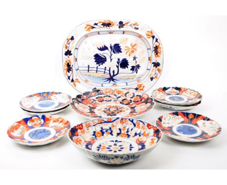 A collection of late 19th century Imari style patterend dish plates and large serving platter. Featuring red and blue botanic