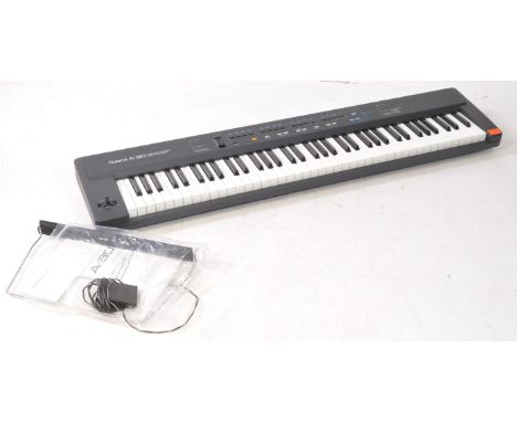 Roland - A 1993 A-30 midi keyboard controller, serial no. AG82565. Manual, power cable, and sheet music stand are present. Un