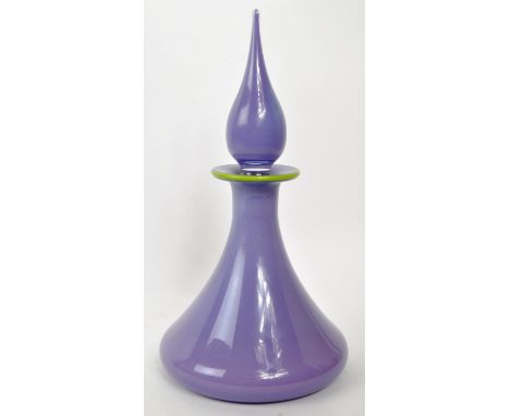 A vintage 20th century purple glass wine decanter. Having a genie stopper with a green rim tapering neck on a wide base. With