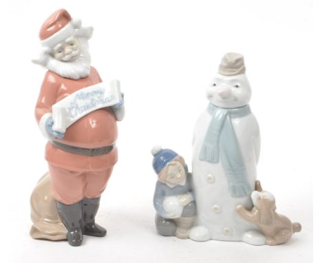 Nao - Lladro - Two contemporary Spanish porcelain christmas figurines, comprising of: a 2000 no. 1399 Father Christmas figure