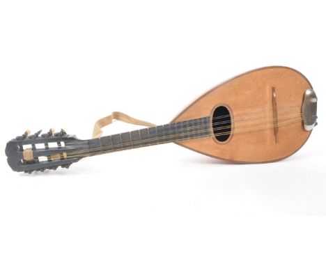 A vintage 20th century bowl back mandolin musical instrument, with a suede strap, 8 strings, and a black painted neck. Measur