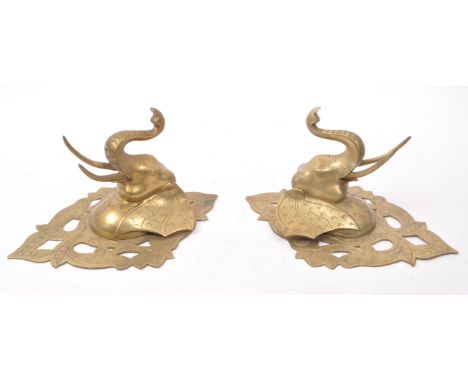 Two vintage 20th century brass elephant sconces, with carved detailing featuring floral shapes and elephant features. Elephan