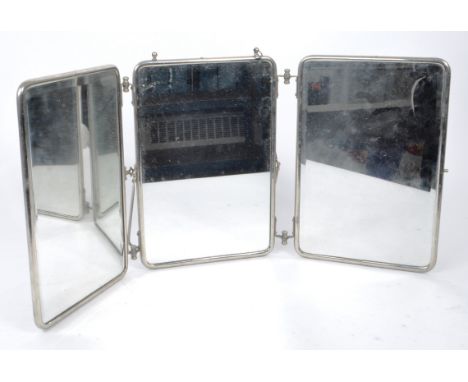 A vintage mid-century folding triptych barber mirror, with leather backing, metal frame, and metal stand. Two out of the thre