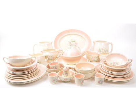 Susie Cooper - Crown Works, Burslem - A collection of mid-century tea service pieces, including egg cups, milk jugs, gravy bo