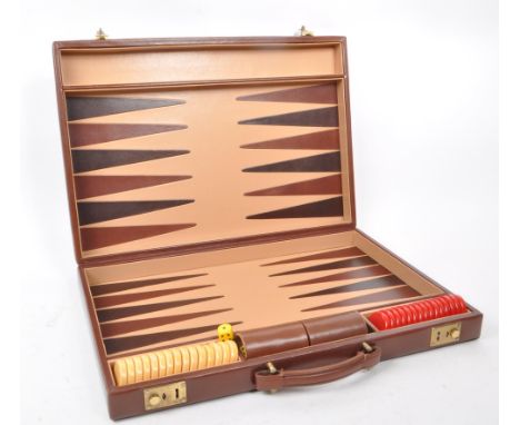 Asprey - A vintage late 20th century circa 1990s leather backgammon attache / briefcase. The case having dark tan leather ext