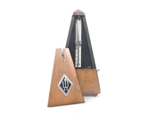 A vintage mid 20th century Wittner German wooden metronome. Featuring metal pendulum and wooden lid with Wittner logo in meta