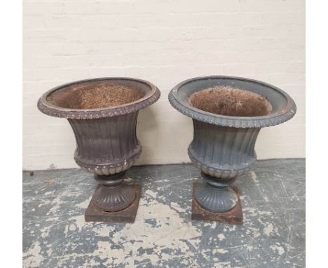 Pair of antique cast iron campagna form garden urns of large size, each with formerly painted lunettes to the border, further