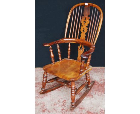 Antique yew wood and elm Windsor rocking chair with hoop frame, stick back with pierced splat, pad arm rests and solid seat, 