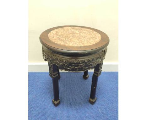 Early 20th century Chinese hardwood jardinière stand, with circular marble inset to the top, above all-over scroll and fruit 