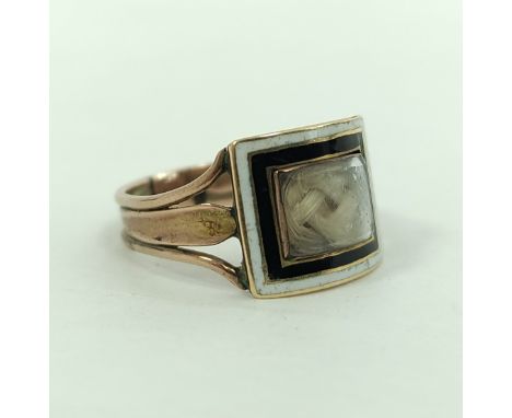 Georgian ribbed gold mourning ring, with curved locket, surrounded by black and white enamel, 'W. Bishop....1816', size 'N'.