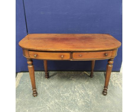 Victorian mahogany side table (formerly an end section from a larger table), with D-end top above two small drawers, on turne