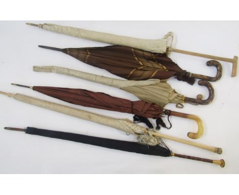 Six vintage silk parasols, including a black silk parasol with gilt-metal mounted malacca cane handle, a brown silk celluloid