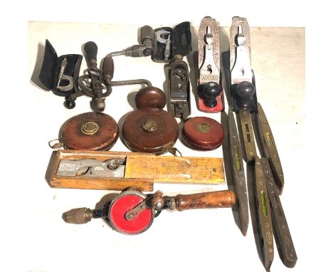 Collection of vintage tools includes wood planes hand drills spirit levels etc 