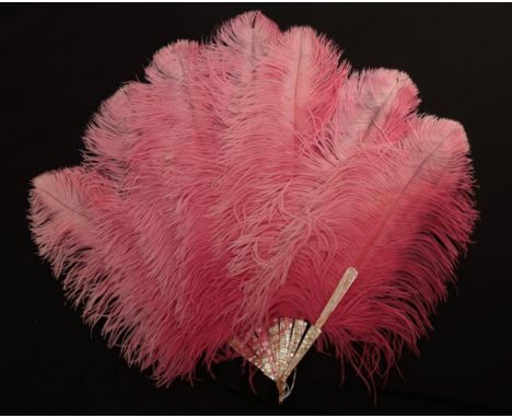 An Early 20th Century Raspberry Pink/Slightly Shaded Ostrich Feather Fan, the feathers mounted on particularly shiny pink mot
