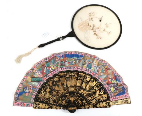 A 20th Century Chinese Fixed Fan of Lacquered Wood, the circular frame containing a cream silk panel delicately embroidered r