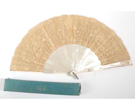 A Late 19th Century Lace Fan, the leaf of Brussels bobbin appliqué backed with gauze, mounted on white mother-of-pearl, the u