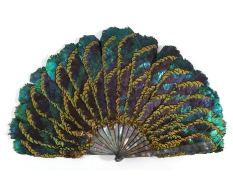 A Fine 19th Century Feather Fan, the mother of pearl monture almost iridescent in shades of dark green and mauve, the guard t
