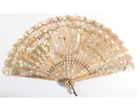A European Pink Mother-of-pearl Brisé Fan, carved and pierced, silvered and gilded in floral sprays, a central roundel with c