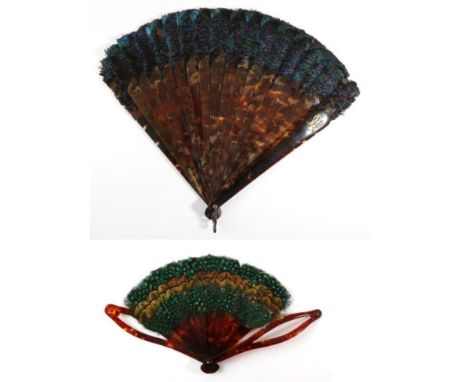 A 19th Century Tortoiseshell Brisé Fan, topped with iridescent blue feathers, the upper guard with a metal monogram, perhaps 