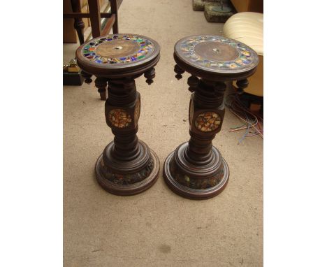A pair of turned wood jardiniere stands inlaid with a tessarae of ceramic fragments.