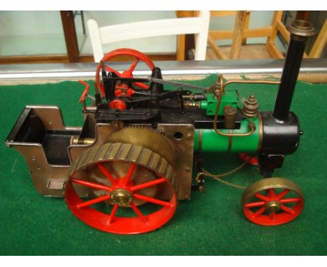 A scratch built steam powered model traction engine. The wheel bears the name D R M (Engineers) Birmingham, England. One whee