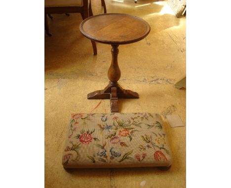 A 20th Century oak low table with a pad footed tapestry footstool.