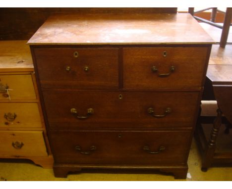 A 19th Century oak chest of drawers, two deep short over two long raised on bracket feet. 