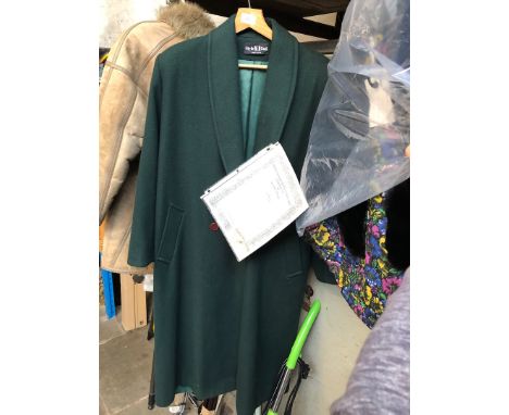 A green long coat used in the making of 'Triple X' film with certificate of authenticity 