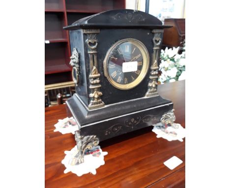 A black slate mantel clock. 