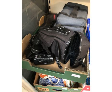 A box of cameras and camera accessories 