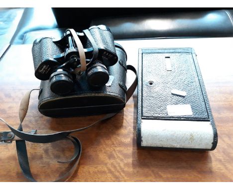 A Kodak camera and a pair of binoculars. 
