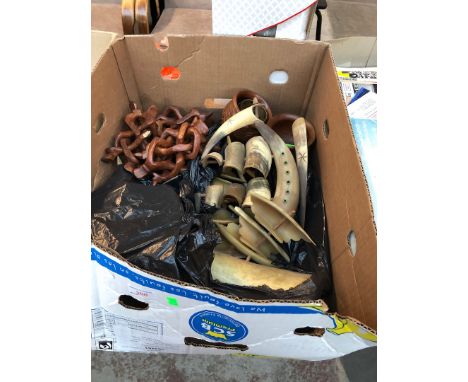 A box containing wood ornaments and bone ornaments 